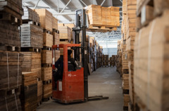 Bild på truck som lyfter låder med borrkärnor i en lagerlokal.